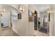 Open hallway with neutral walls, tile flooring, and arched doorways to adjoining rooms at 16207 W Moreland St, Goodyear, AZ 85338