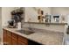 Granite countertops and stainless steel sink in a brightly lit kitchen at 16207 W Moreland St, Goodyear, AZ 85338