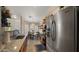 Bright kitchen featuring stainless steel appliances, granite counters, and a dining area view at 16207 W Moreland St, Goodyear, AZ 85338