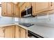 Bright kitchen with stainless steel microwave, smooth countertops, and wood cabinetry at 17200 W Bell Rd # 800, Surprise, AZ 85374