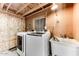 Interior view of unfinished laundry room with washer, dryer, and utility sink at 17200 W Bell Rd # 800, Surprise, AZ 85374