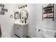 Modern bathroom features a round mirror, gray vanity, and stylish fixtures at 17445 N 185Th Dr, Surprise, AZ 85374