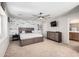 Spacious bedroom features a statement wall, ceiling fan, and an ensuite bathroom at 17445 N 185Th Dr, Surprise, AZ 85374