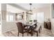 Warm and inviting dining room with rustic wood table, bench seating, and plantation shutters at 17445 N 185Th Dr, Surprise, AZ 85374