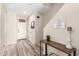 Inviting entryway featuring wood-look tile flooring, a decorative table, and a charming welcome sign at 17445 N 185Th Dr, Surprise, AZ 85374