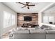 Stylish living room showcasing a reclaimed wood accent wall, a cozy sectional, and plantation shutters at 17445 N 185Th Dr, Surprise, AZ 85374