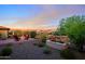 Serene backyard featuring a fire pit, lush landscaping, soothing water feature, and mountain views at 17913 E Vista Desierto --, Rio Verde, AZ 85263