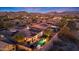 Expansive aerial view of home with pool, patio, and mountain views at dusk, in the community at 18059 W Ocotillo Ave, Goodyear, AZ 85338