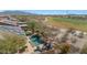 Aerial view of a house with a pool, outdoor kitchen, and golf course views, highlighting outdoor entertainment at 18059 W Ocotillo Ave, Goodyear, AZ 85338