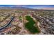 Aerial view of community and golf course home with mountain backdrop, manicured lawns, and neighborhood streets at 18059 W Ocotillo Ave, Goodyear, AZ 85338