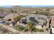 Aerial view of a home with a pool, solar panels, and mountain views, showcasing outdoor living at 18059 W Ocotillo Ave, Goodyear, AZ 85338