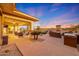 Expansive covered patio flows to the pool area, featuring an outdoor kitchen and cozy fireplace, perfect for entertaining at 18059 W Ocotillo Ave, Goodyear, AZ 85338