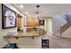 Elegant wet bar with granite countertop, custom cabinets, and seamless access to a staircase at 18059 W Ocotillo Ave, Goodyear, AZ 85338