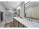 Bright bathroom with double vanity, quartz countertops, and a spacious glass shower with custom tile at 18059 W Ocotillo Ave, Goodyear, AZ 85338