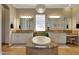 Bright primary bathroom featuring a soaking tub, chandelier, double sinks, and neutral finishes at 18059 W Ocotillo Ave, Goodyear, AZ 85338