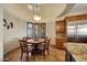 Cozy breakfast nook with round table, chairs, and lots of natural light and custom cabinetry at 18059 W Ocotillo Ave, Goodyear, AZ 85338