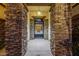 Inviting entrance featuring stone pillars and gated entry to a courtyard at 18059 W Ocotillo Ave, Goodyear, AZ 85338