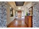 Warm and inviting foyer with hardwood floors, stone accents, and a decorative cabinet at 18059 W Ocotillo Ave, Goodyear, AZ 85338