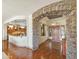 Inviting foyer featuring stone archway, hardwood floors, and an open layout at 18059 W Ocotillo Ave, Goodyear, AZ 85338