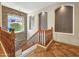 View of the staircase featuring natural light and a stone accent wall at 18059 W Ocotillo Ave, Goodyear, AZ 85338