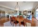 Open-concept living room with fireplace, hardwood floors, and dining room at 18059 W Ocotillo Ave, Goodyear, AZ 85338