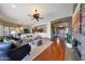 Open-concept living room with hardwood floors, a fireplace, and lots of light at 18059 W Ocotillo Ave, Goodyear, AZ 85338