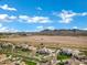 Scenic aerial view of a luxury home in a community near Phoenix, Arizona, with mountain views and landscaping at 20125 E Melissa Pl, Queen Creek, AZ 85142