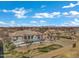 Aerial view of a luxury home with a modern backyard pool and patio area surrounded by nice landscaping and community at 20125 E Melissa Pl, Queen Creek, AZ 85142