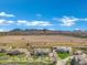 Expansive aerial view of a luxury home and landscape, set against a backdrop of majestic mountains at 20125 E Melissa Pl, Queen Creek, AZ 85142