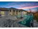 Beautiful backyard oasis featuring a sparkling pool, covered patio, and a fire pit, creating an ideal space for outdoor entertaining at 20125 E Melissa Pl, Queen Creek, AZ 85142