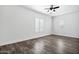 A bedroom with wood floors, white walls, baseboards, and plantation shutters at 20125 E Melissa Pl, Queen Creek, AZ 85142