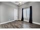 Bedroom with gray walls and sleek wooden flooring with a window on the right at 20125 E Melissa Pl, Queen Creek, AZ 85142