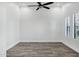 Bright bedroom with ceiling fan, plantation shutters and stylish wood-look floors at 20125 E Melissa Pl, Queen Creek, AZ 85142