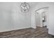 Dining room featuring hardwood floors, white walls, and modern chandelier at 20125 E Melissa Pl, Queen Creek, AZ 85142