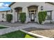 Close-up showcasing the decorative front door, stone walkway and manicured landscaping at 20125 E Melissa Pl, Queen Creek, AZ 85142