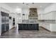 Gourmet kitchen featuring stainless steel appliances, granite countertops, and stone accent wall at 20125 E Melissa Pl, Queen Creek, AZ 85142