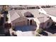 Aerial view of a three-car garage home, beautifully landscaped with putting green on an expansive lot at 2089 E Lynx Pl, Chandler, AZ 85249