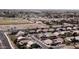 Overhead view of a neighborhood, showing a mix of homes, streets, a green field, and commercial facilities at 2089 E Lynx Pl, Chandler, AZ 85249