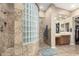 Elegant bathroom showcases a glass block shower, custom tile work, and vanity area with drawers at 2089 E Lynx Pl, Chandler, AZ 85249