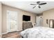 Comfortable bedroom showcasing modern furnishings, a ceiling fan, and private balcony access for relaxation at 2089 E Lynx Pl, Chandler, AZ 85249