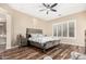 Serene bedroom with a ceiling fan, plantation shutters, and wood floors for a calming retreat at 2089 E Lynx Pl, Chandler, AZ 85249