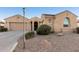 Charming exterior view of a tan single-story home with manicured landscaping and ample parking at 2089 E Lynx Pl, Chandler, AZ 85249