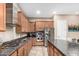 Gourmet kitchen featuring stainless steel appliances, a granite island, and custom cabinets offering ample storage at 2089 E Lynx Pl, Chandler, AZ 85249