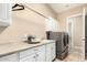 Well-equipped laundry room featuring ample counter space, cabinets, and modern washer and dryer units at 2089 E Lynx Pl, Chandler, AZ 85249