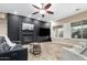 Cozy living room with fireplace, media center, ceiling fan and plenty of natural light at 2089 E Lynx Pl, Chandler, AZ 85249