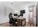 Bright home office with stylish decor, custom shelving, shutters, and a modern wooden desk at 2089 E Lynx Pl, Chandler, AZ 85249