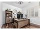 Bright home office with stylish decor, custom shelving, shutters, and a modern wooden desk at 2089 E Lynx Pl, Chandler, AZ 85249