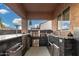 Outdoor kitchen with stainless steel grill, sink, and ample counter space, perfect for al fresco dining at 2089 E Lynx Pl, Chandler, AZ 85249