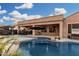 Sparkling pool surrounded by outdoor seating and a fire pit offers relaxation and entertainment at 2089 E Lynx Pl, Chandler, AZ 85249