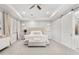 Bright bedroom featuring a tray ceiling, upholstered headboard, and a sliding barn door at 20981 E Watford Dr, Queen Creek, AZ 85142